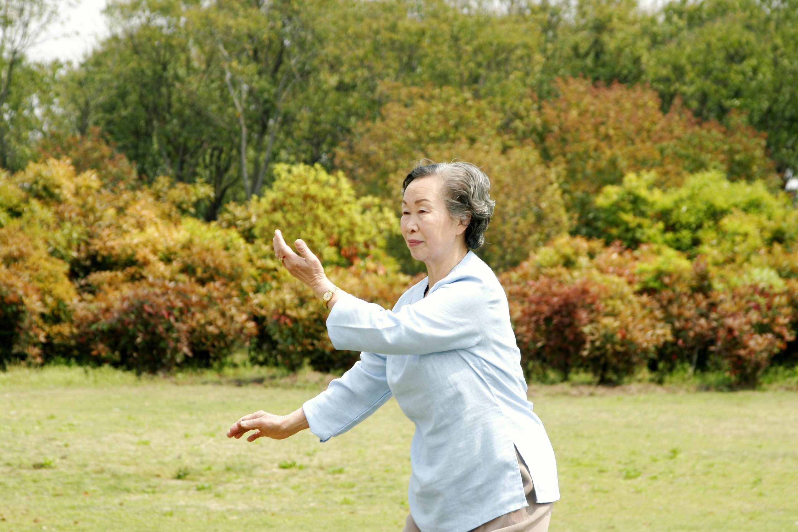 Old woman practicing tai chi